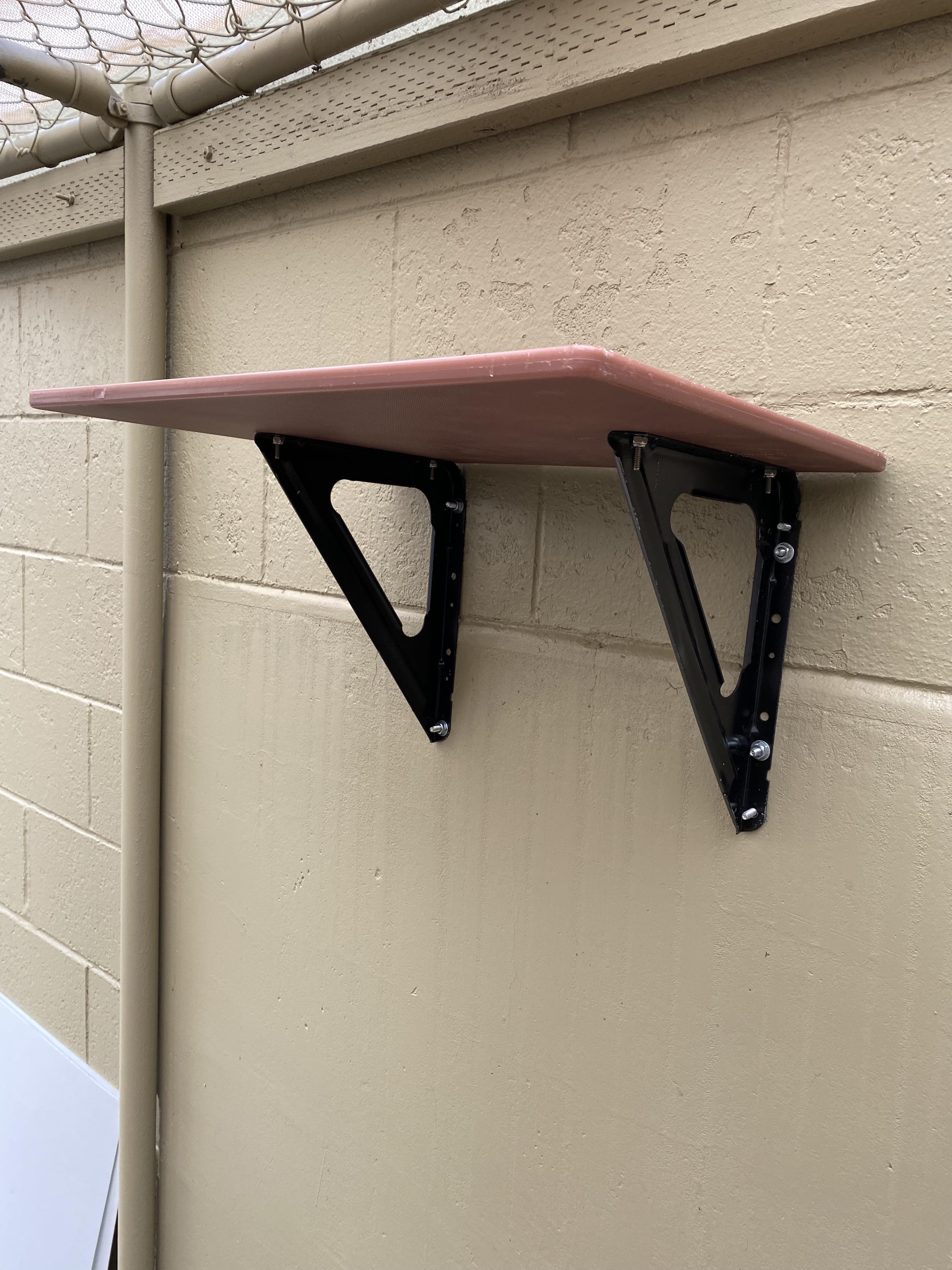 we used metal brackets drilled into cement wall to install cutting board perches